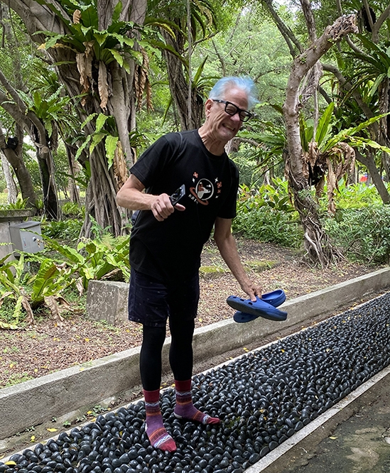 Nik "massaging" his feet on a stone foot massager